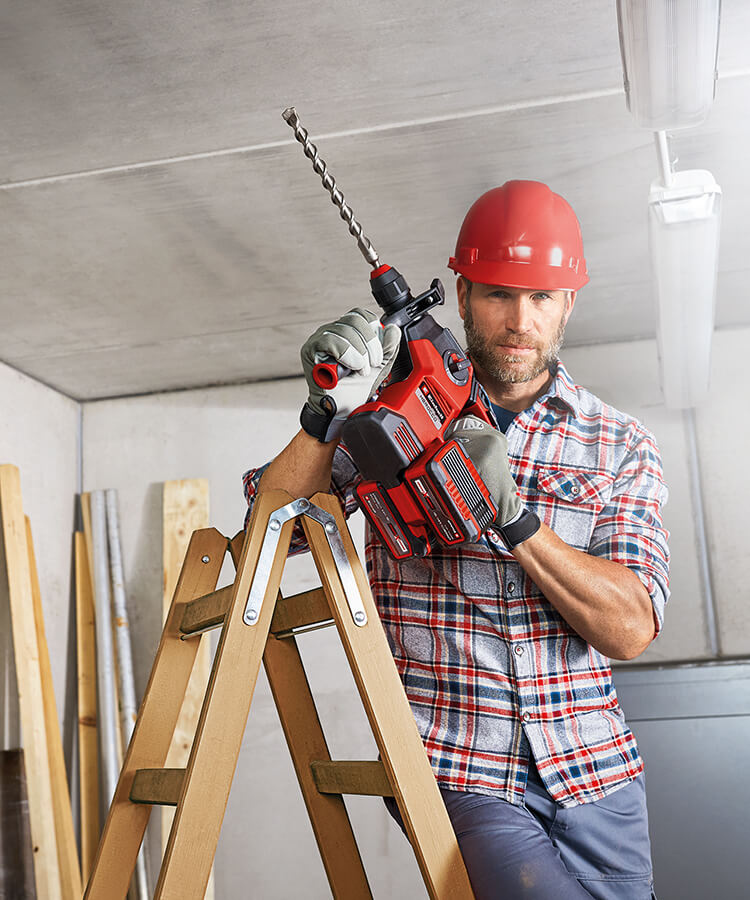 Picture of a man working with a cordless rotary hammer.