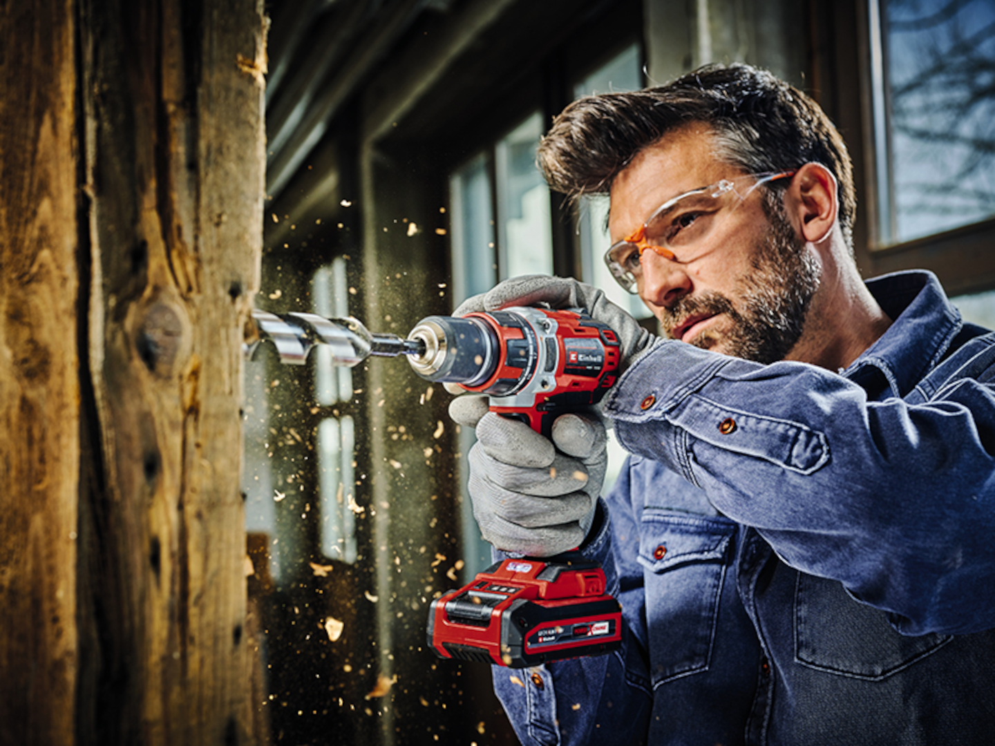 a man using a brushless drill driver