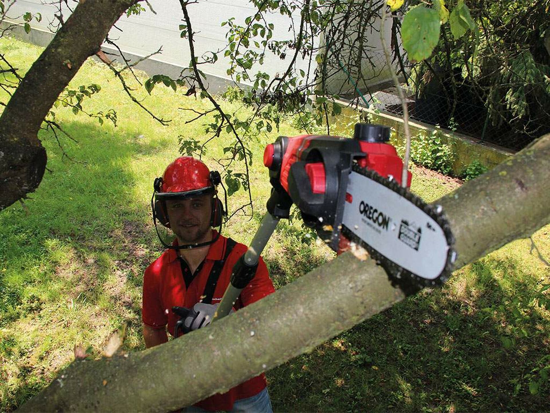 man cuts a branch with a high pruner