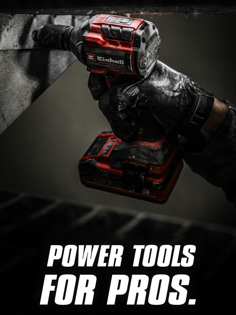 A hand holds a red cordless impact wrench being used on a metal beam, with the text "Power Tools for Pros".